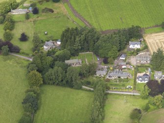General oblique aerial view of the village centred on the church taken from the S.
