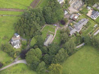 General oblique aerial view of the village centred on the church taken from the WSW.