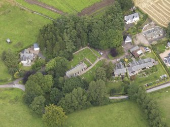 General oblique aerial view of the village centred on the church taken from the SSW.