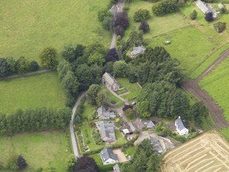 General oblique aerial view of the village centred on the church taken from the SE.