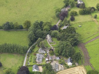 General oblique aerial view of the village centred on the church taken from the E.