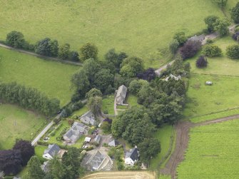 General oblique aerial view of the village centred on the church taken from the ENE.