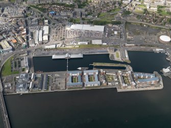 General oblique aerial view of the harbour area, centred on the Victoria Dock taken from the SE.