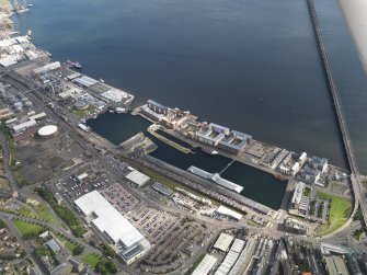 General oblique aerial view of the harbour area, centred on the Victoria Dock taken from the NW.