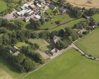 General oblique aerial view of the Murroes Estate centred on the church taken from the NW.