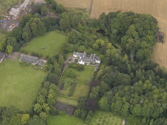 General oblique aerial view of the Grange of Gagie centred on the house taken from the SSW.