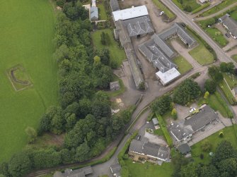 General oblique aerial view of the Tealing Home Farm centred on the dovecot taken from the S.