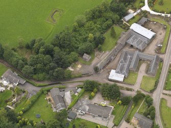 General oblique aerial view of the Tealing Home Farm centred on the dovecot taken from the SE.