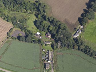 General oblique aerial view of Woodside Cottages, centred on the mill, taken from the SSW.