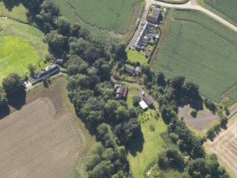General oblique aerial view of Woodside Cottages, centred on the mill, taken from the NW.