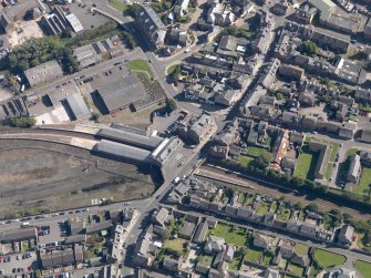 General oblique aerial view of central Arbroath, centred on the railway station, taken from the NNW.