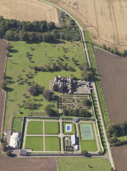 General oblique aerial view of the Ethie estate, centred on Ethie Castle, taken from the E.
