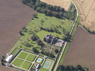 General oblique aerial view of the Ethie estate, centred on Ethie Castle, taken from the ENE.