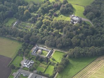 General oblique aerial view of the Dunninald estate, centred on Dunninald Mains Farmhouse,  taken from the ENE.
