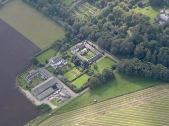 General oblique aerial view of the Dunninald estate, centred on Dunninald Mains Farmhouse, taken from the E.