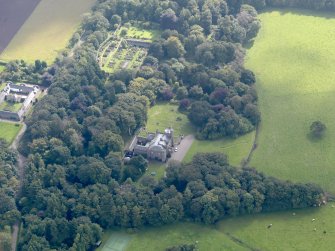General oblique aerial view of the Dunninald estate, centred on Dunninald Castle, taken from the NNW.