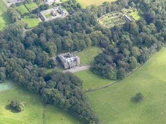 General oblique aerial view of the Dunninald estate, centred on Dunninald Castle, taken from the WNW.
