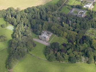 General oblique aerial view of the Dunninald estate, centred on Dunninald Castle, taken from the SSW.