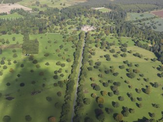 General oblique aerial view of the policies of Glamis Castle, looking up the Avenue centred on Glamis Castle, taken from the South.
