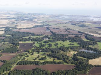 General oblique aerial view from a distance of Kinnaird Castle estate and policies, centred on Kinnaird Castle, taken from the SW.