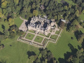 General oblique aerial view of Kinnaird Castle estate, centred on Kinnaird Castle, taken from the SSW.