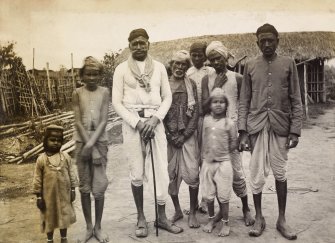 View of group of people, probably in India. 
Titled: 'Group of Kyahs Pathalipan'

