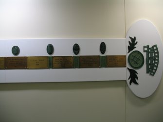 View of 'Narratives' (The Bed Plaque Project'), along wall of N corridor on first floor.