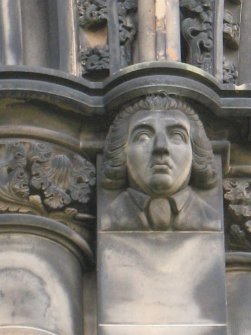 View of head of James Beattie, at top of pilaster on E side (facing E).