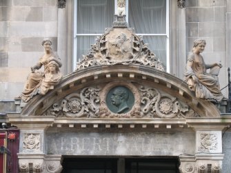 View of pediment above entrance to Albert Gallery (after restoration), showing sculptures representing Sculpture and Poetry, and a bronze portrait head of Prince Albert.