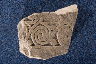 View of cross-slab fragment, Drainie no 24, with spiral decoration. 
