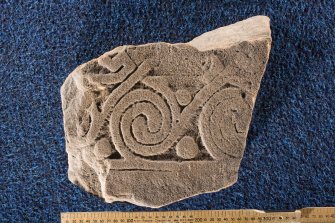 View of cross-slab fragment, Drainie no 24, with spiral decoration (with scale)