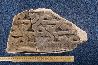 View of fragments of cross slab, Drainie nos 25 and 27 (with scale)