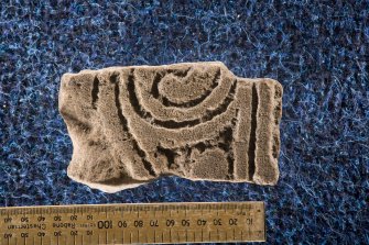 View of cross-slab fragment with spiral decoration (including scale)