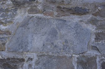 View of stone set into rear wall of church (daylight)