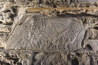 View of stone set into rear wall of church (flash with scale)