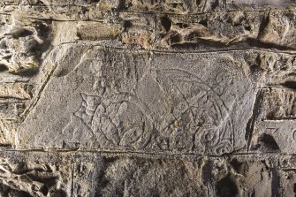 View of stone set into rear wall of church (flash)