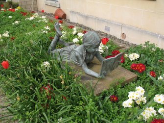 View of sculpture 'Girl Reading', in garden area to left of main entrance.