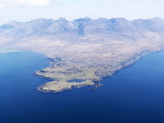 General oblique aerial view centred on Loch na h-Airde, the 'Viking Canal’ and Rubh' an Dunain with the Cuillin Hills in the background, taken from the SW.