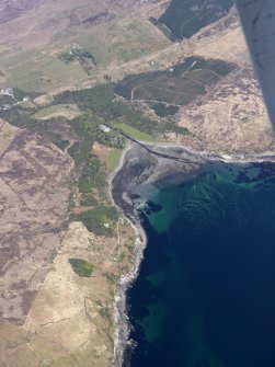 General oblique aerial view centred on Kilmarie House, its grounds and the remains of the fish trap, taken from the S.