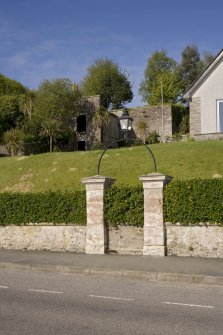 View of lantern above gates in boundary wall to 3 Ardbeg Road, Ardbeg, Rothesay, Bute, from NE