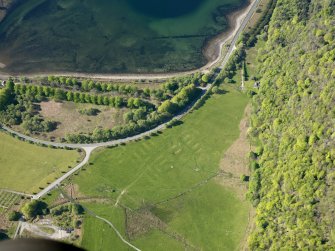 Oblique aerial view of the remains of the Shire Camp, Combined Operations Training Centre, and the Loch Dhu avenue, taken from the NE.