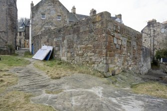 General view from NE. Note the cut grooves in the bedrock to aid livestock, passengers and wheeled traffic up and down Sealscraig Lane. The two roofless buildings to the rear of 9 Edinburgh Road are on the right. Both these buildings were still roofed in 1888.