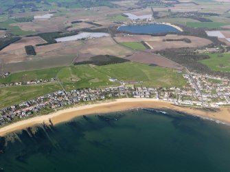 General oblique aerial view of Elie Golf Courses and the village with Kilconquhar Loch in the background, taken from the S.