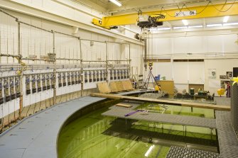 Interior. Curved wave tank building. View of modular work platforms, signal processing receivers (left)