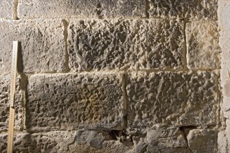 Detail of possible carved stones built into wall in basement of church  (with scale)