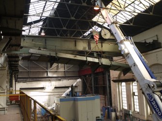 Interior. Crane 1 demolition: View of walkway being lowered to shop floor of Main Range