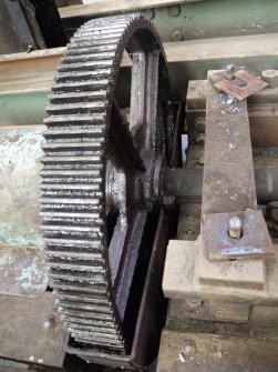 Interior. Crane 1 demolition: View of gear wheel on shaft which allowed the crane to move along the gantry