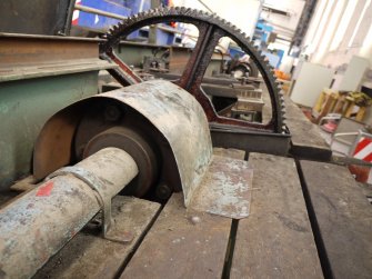 Interior. Crane 1 demolition: View of west walkway, mid point geared wheel which allowed the shaft to turn and move the crane along the gantry