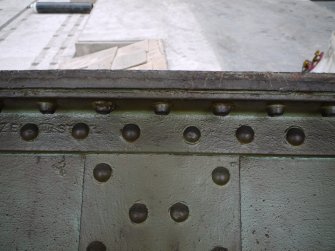 Interior. Main Range. Crane 2 demolition. Detail view of plates of main beam and rivet pattern, quarter inch thick  steel plate cut through to allow lowering of beam onto floor.
