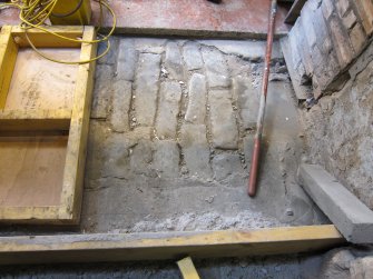 Interior. View of Building 1A1, south west end junction with north end of Building 2. The original floor level of the courtyard to the south of 1A1 prior to the building of Building 2 or the original floor covering of Building 2.